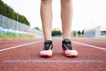 Feet of a runner, standing on race track - GIOF04792