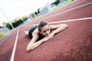 Austria, Teenage girl running on track, portrait stock photo