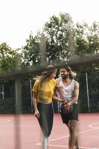 Junges Paar hat Spaß auf dem Basketballplatz, lizenzfreies Stockfoto