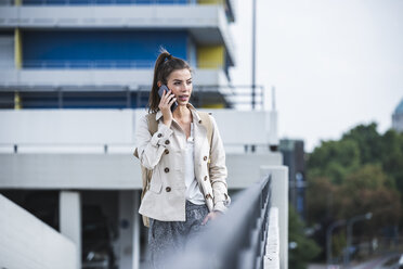 Young businesswoman using smartphone in he city - UUF15635