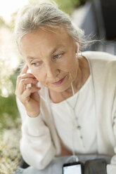 Portrait of senior woman with cell phone and earphones - VGF00055