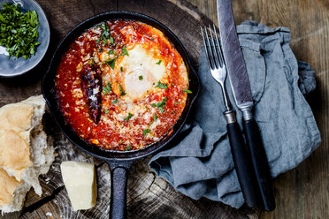 Eggs in Purgatory, eggs, baked in very spicy tomato sauce, sprinkled with parsley and parmegiano - SBDF03788