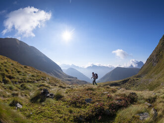 Italy, Lombardy, Bergamasque Alps, hiker on the way to Passo del Gatto, Cima Bagozza and Mount Camino - LAF02117