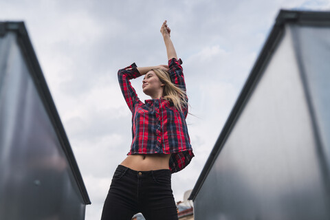 Fashionable young woman on rooftop stock photo