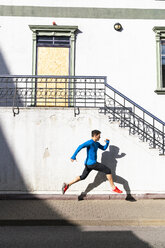 Sportive man exercising on pavement - KKAF02703