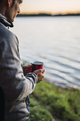 Man looking at the lake, drinking coffee - KKA02785