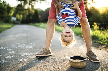 Portrait of laughing toddler having fun with his father outdoors - HAPF02795