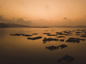 Indonesia, Lombok, Aerial view of lobster farm in the evening - KNTF02230