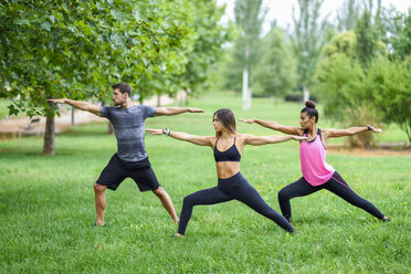 Young people exercising yoga in a park - JSMF00529