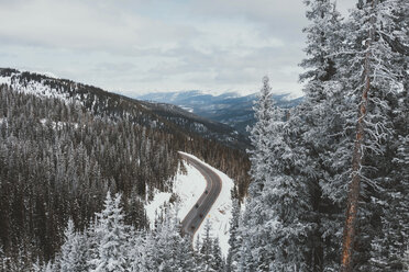 Aerial view of mountain road against cloudy sky during winter - CAVF50726