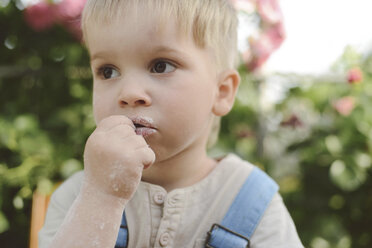 Close-up of thoughtful boy looking away in yard - CAVF50820