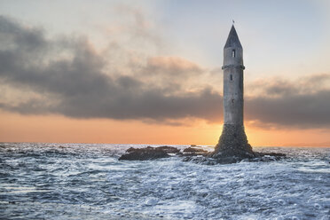 Low angle view of lighthouse amidst sea against cloudy sky during sunset - CAVF50938