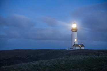 Illuminated Yaquina Head Light against sky at night - CAVF50947