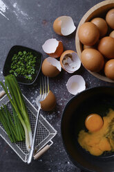 High angle view of eggs with spring onions on table - CAVF51002