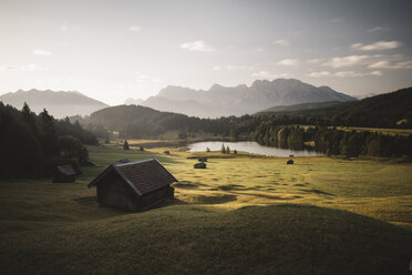 Scenic view of lake and green landscape against sky - CAVF51011