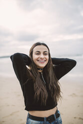 Portrait of happy young woman on the beach - RAEF02201