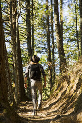 Full length of man walking in forest - CAVF51066