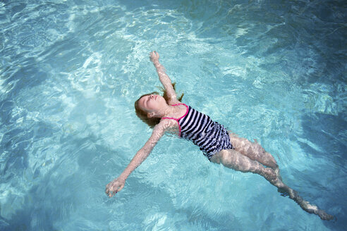 High angle view of girl in swimwear swimming in pool - CAVF51186