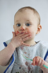 Portrait of baby girl eating mush - JLOF00280