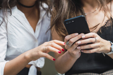 Woman's hands holding smartphone, close-up - KKAF02818