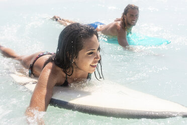 Young couple having fun at he sea, surfing - WPEF01067