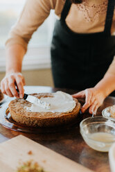 Woman in apron baking vegetarian cake - CUF46343