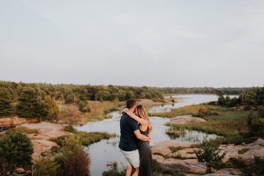 Couple enjoying view of river, Algonquin Park, Canada - CUF46356