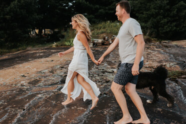 Couple walking with pet dog, Algonquin Park, Canada - CUF46360