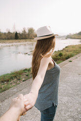 Girlfriends taking walk by river, Belluno, Veneto, Italy - CUF46467