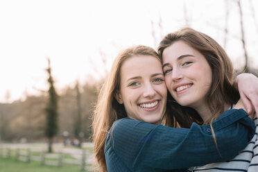 Happy girlfriends in park - CUF46491