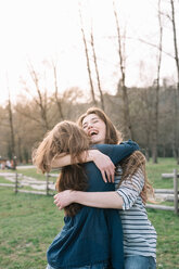 Happy girlfriends in park - CUF46492