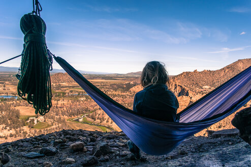 Rock climber on hammock on summit, Smith Rock State Park, Oregon, USA - ISF20035