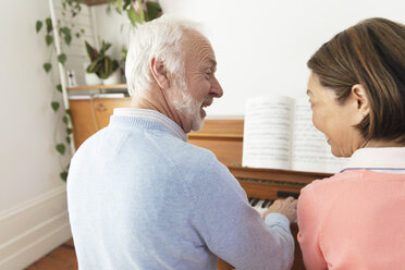 Active senior couple playing piano - CAIF22223