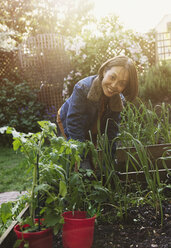 Portrait smiling active senior woman gardening - CAIF22227