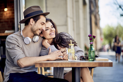 Happy affectionate young couple at outdoors cafe stock photo