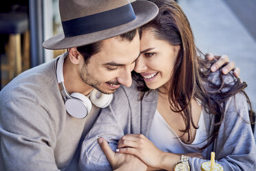 Happy affectionate young couple cuddling outdoors - BSZF00792