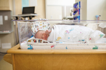 Neugeborener Junge schläft in der Krippe im Krankenhaus - CAVF51589