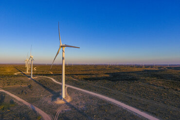 Windmills on field against blue sky - CAVF51687