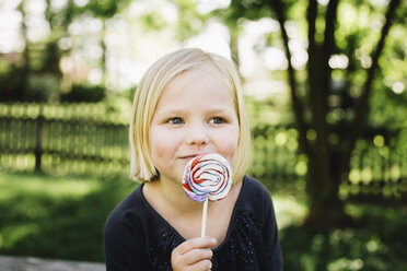 Close-up of girl looking away while eating lollipop - CAVF51858