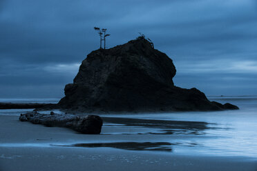 Scenic view of rock formations on shore against cloudy sky at Olympic National Park - CAVF51910