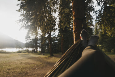 Low section of woman relaxing on hammock in forest - CAVF51939