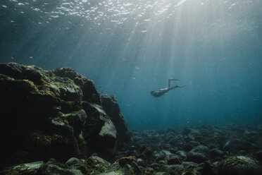 Low angle view of carefree woman scuba diving undersea - CAVF51984