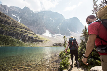 Hikers walking by river at Banff National Park - CAVF52023