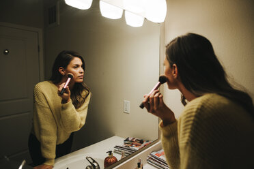 Woman applying make-up reflecting on mirror - CAVF52287