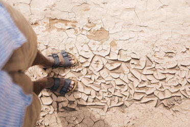 Low section of man standing at desert - CAVF52310