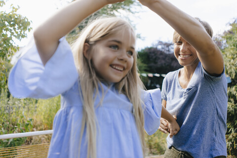 Mother and daughter having fun in garden stock photo