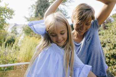 Mother and daughter having fun in garden - KNSF05093