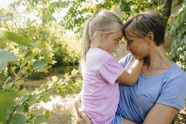 Mother carrying daughter in garden - KNSF05102