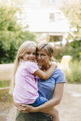 Porträt einer lächelnden Mutter mit ihrer Tochter im Garten - KNSF05119
