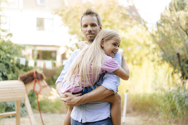 Portrait of father carrying daughter in garden - KNSF05128